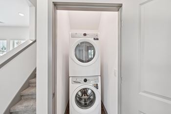 A white washing machine and dryer in a small laundry room at The Hadley - North Port, FL Apartments, Florida, 34287